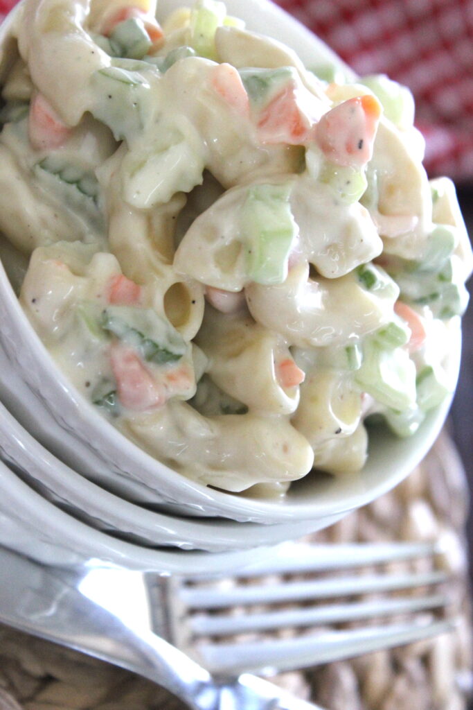 macaroni salad that is creamy with carrots and celery