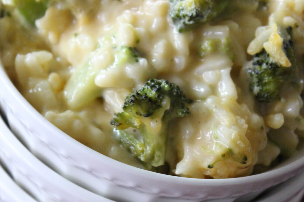 cheesy broccoli rice in a white bowl