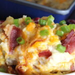 potatoes with cheese, green onions and bacon in a dsih