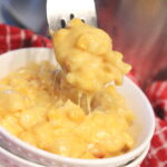 macaroni and corn casserole on a fork over a bowl